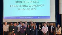 A large group of participants stands together in front of a screen showing “Frontiers in Cell Engineering Workshop – October 10, 2025.”